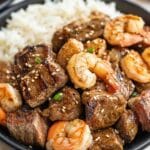 Hibachi steak and shrimp in meal prep container with rice and veggies